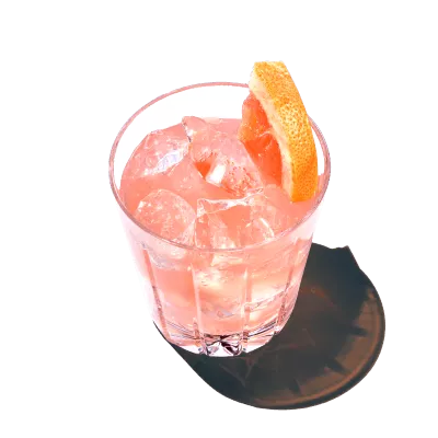 A glass of a spicy paloma is served with ice cubes and vodka from pinnacle vodka.